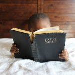 child holding bible