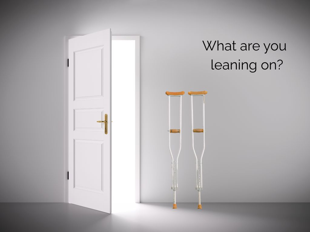 Unused crutches beside an open doorway, representing letting go of collective control